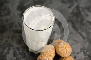 Flatlay, a delicious, refreshing summer drink in a glass, a milkshake made of milk and ice cream. Gingerbread on a dark