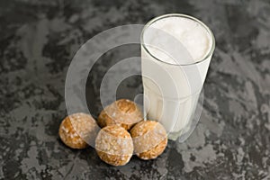 Flatlay, a delicious, refreshing summer drink in a glass, a milkshake made of milk and ice cream. Gingerbread on a dark