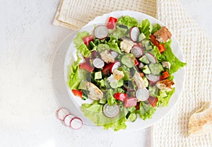 Flatlay. Fattoush salad with vegetables and toasted pita bread on a napkin.