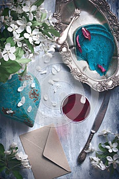 Flatlay food background - empty wooden table with cheese pieces, red wine and silver antique dishwear