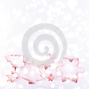 Flatlay with holiday tree and snowflake copper cookie cutters on white sparkling background. Holiday, Christmas and New