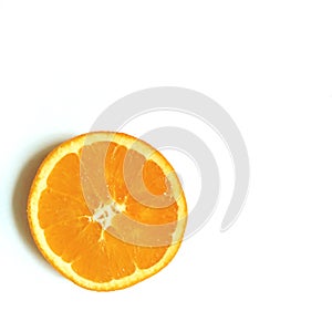 Flatlay layout slice of orange in the center of white background