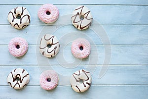 Flatlay of Pink and White Donuts on Light Blue Table