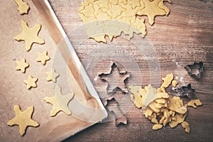Flatlay, raw dough with cutters and griddle for sweet christmas cookies