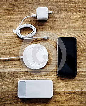 Flatlay of smartphone accessories on wooden table