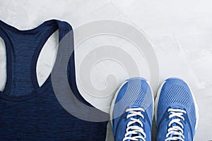 Flatlay sport composition with outfit blue sneakers and t-shirt