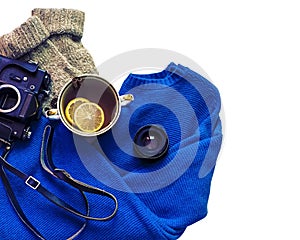 Flatlay of tea with lemons, oldschool camera, sweater and socks. Cozy space, trend instagram photo. Isolated