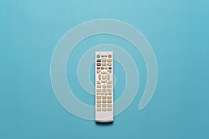 Flatlay of white TV remote isolate on cyan background