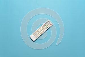 Flatlay of white TV remote isolate on cyan background