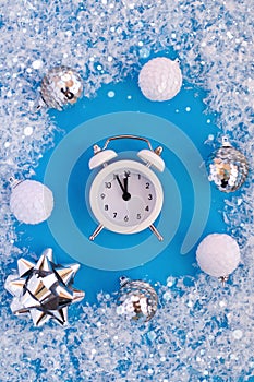 Flatley Christmas card with white and silver decor and alarm clock on blue background under snow