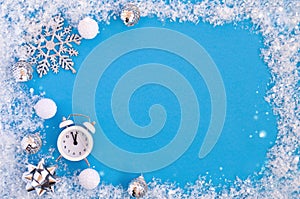 Flatley Christmas card with white and silver decor and alarm clock on blue background under snow