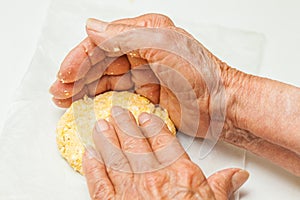 Flatten the dough balls to form the arepa typical shape