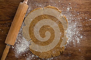 Flattened dough on a wooden table