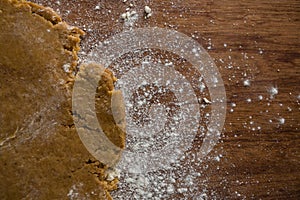 Flattened dough on a wooden table