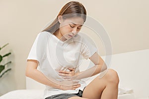 Flatulence ulcer, asian young woman, girl hands in belly, stomachache from food poisoning, abdominal pain and digestive problem,