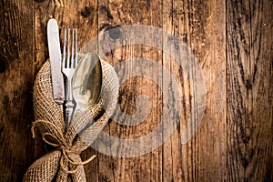 Flatware the old wooden table with a rustic style.