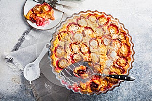 Flaugnarde or Clafoutis - French dessert with plums, large pancake baked in oven