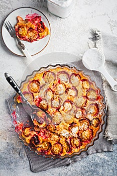 Flaugnarde or Clafoutis - French dessert with plums, large pancake baked in oven