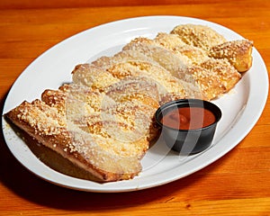 Flavored Fast Food Dish - Parmesan Bread Sticks on Indoor Wooden Table