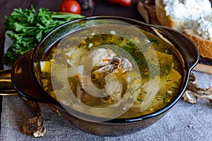 Flavored soup of dried porcini mushrooms in a glass tureen.