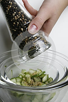 Flavoring the fresh cucumber salad photo