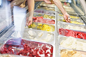 Flavors various ice cream in Rome, Italy. Italian gelateria. Assortment of colorful gelato on cafe showcase.