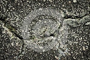 Flaws and defects give to weakness shown by cracked pavement. Imperfections and rough asphalt. rock photo