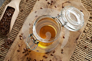 Flax seed oil in a jar, with linseeds