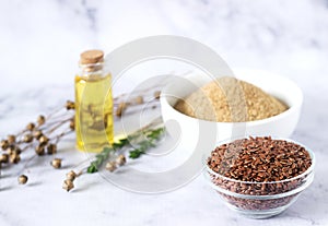 Flax seeds, flax flour, oil with sprouts and flax seed boxes on a light background