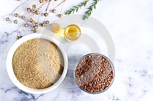 Flax seeds, flax flour, oil with sprouts and flax seed boxes on a light background