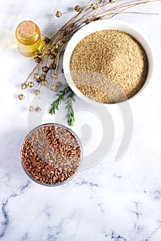 Flax seeds, flax flour, oil with sprouts and flax seed boxes on a light background