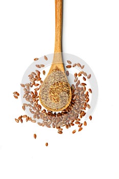 Flax seeds. Flaxseed powder in a wooden spoon. Standing on a white background