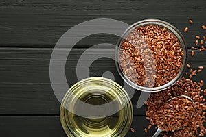 Flax seeds and oil in bowl on black background. Space for text