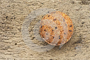 Flax seeds pressed into a round briquette. It is used as feed for animals, birds and fish. One of the feed ingredients. Copy space