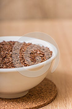 Flax seeds in a white ceramical bowl.