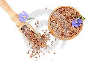 Flax seeds in wooden bowl with flower isolated on white background. flaxseed or linseed. Cereals. top view