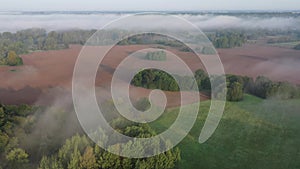 Flaying fog above spring morning landscape, aerial