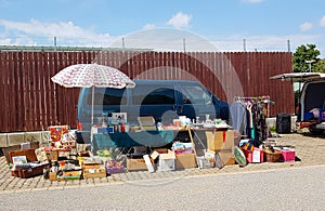 Flea market stand with car and lots of old things to sale