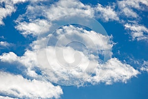 Fleecy clouds on blue sky photo