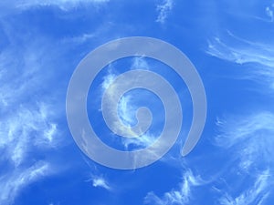 Feather clouds in blue sky photo