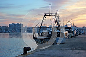 Fleet of fishing boats docked at the Santa Pola harbor at dawn