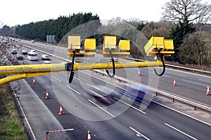 Fleet, Hampshire, UK - March 11th 2017: Average speed cameras in operation on the M3 Motorway with intentional motion blur on vehi
