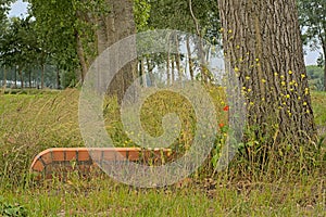 Small brick wall bordering a canal in the flemish countryside photo