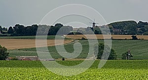 Flemish landscape with farmland and hills with forest