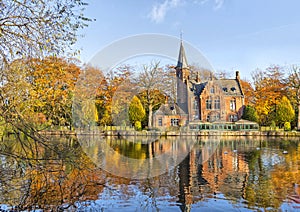 Flemish style building reflecting in Minnewater lake, Bruges