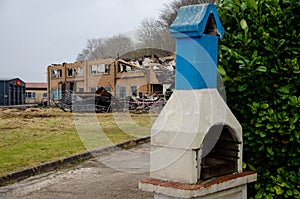 Flensburg Fahrensodde Burning Fire Airplane hanger. View of an outdoor blue and white chimney in foreground photo