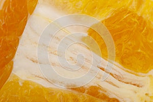 Flesh of juicy ripe orange as background or backdrop, close-up abstract blurred image