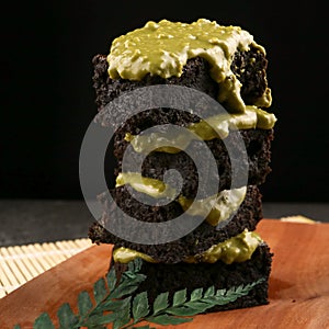 Fleshly baked greentea brownies on wooden background photo