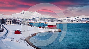 Flesveinen bridge on the shore of Offersoystraumen fjord. Amazing winter sunrise on Vestvagoy island.