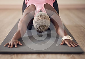 Flexibility, yoga or black woman in house for stretching, wellness or body posture in childs pose or routine. Relax, zen